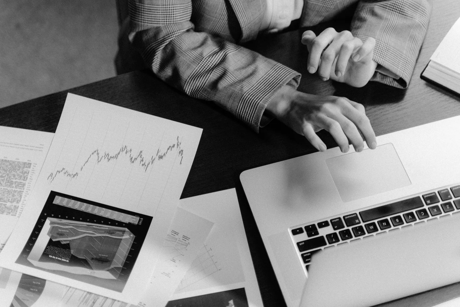 Focused workspace with business charts and laptop for financial analysis. Influencer analytics tools checklist for agencies