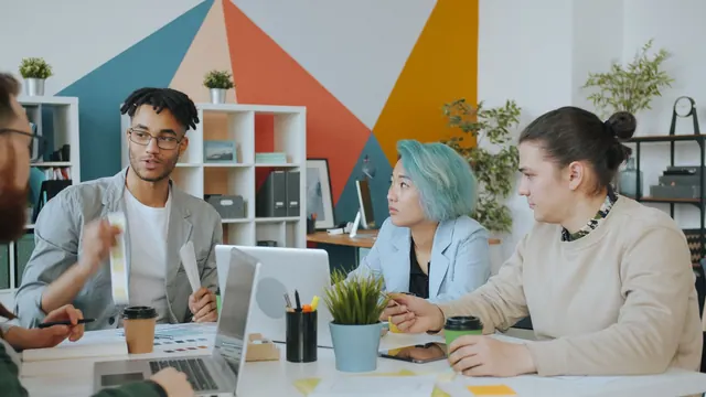 Diverse team engaging in a collaborative meeting in a vibrant, modern office space. Best campaign management tools platforms 2027: guide