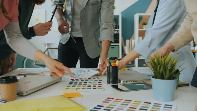 A group of people collaborating on a design project at a white office table Hands of creative designers are working with color palettes during meeting in office while team of young. Campaign management tools trends 2027: facts and context