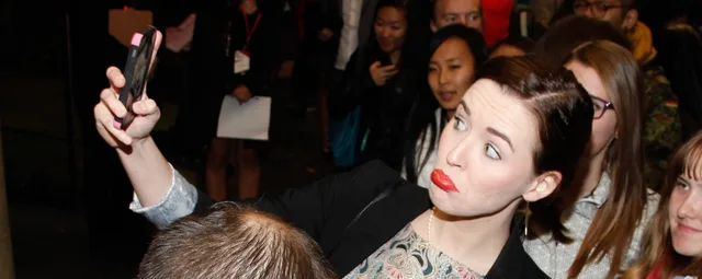 Attendee at the 2013 Buffer Festival Gala mugs for a selfie. UGC platforms: four checks that decide what you can do with the footage